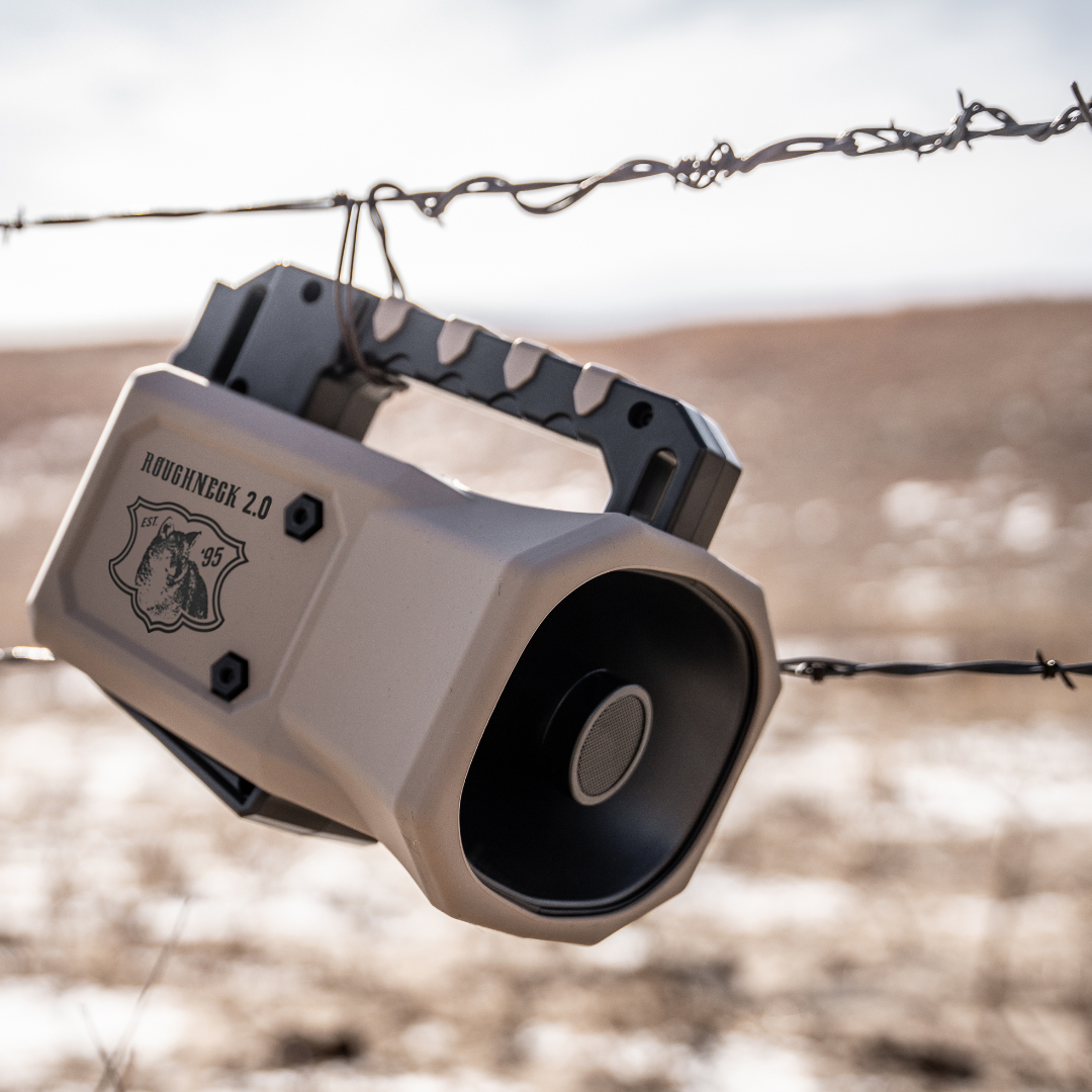E-Caller 'Roughneck 2.0' hanging on barbed wire with a midwest landscape in the background. 