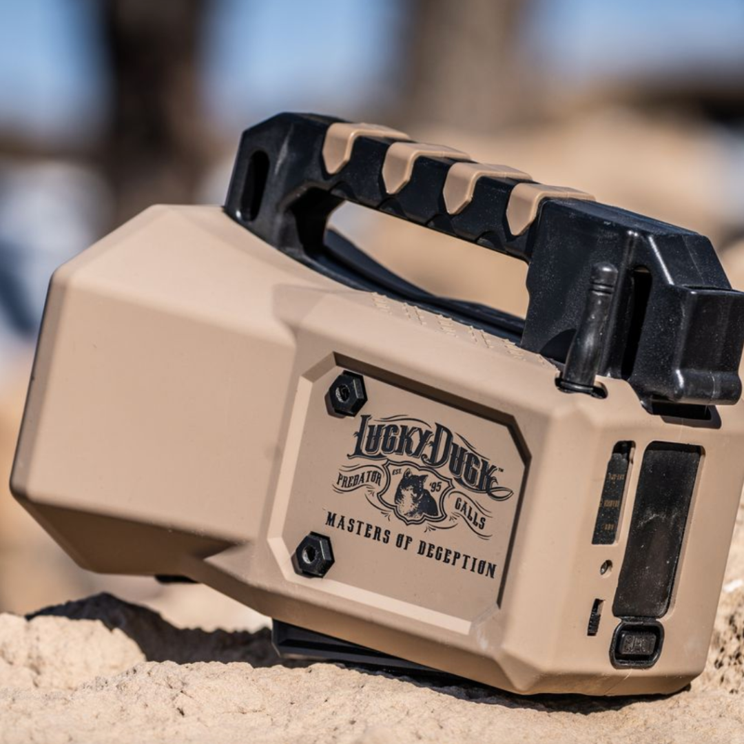 Close-up of a Roughneck 2.0 E-Caller with 'Lucky Duck' branding on a sandy background